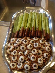 there is a platter full of food that includes asparagus and pretzels