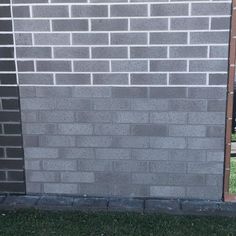 a red fire hydrant sitting next to a brick wall