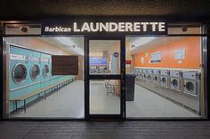 the front entrance to a launderette store with washers and dryers in it