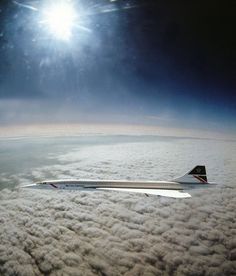 an airplane is flying high above the clouds