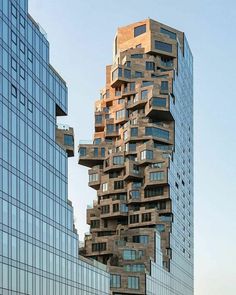 a tall building with lots of windows next to other buildings