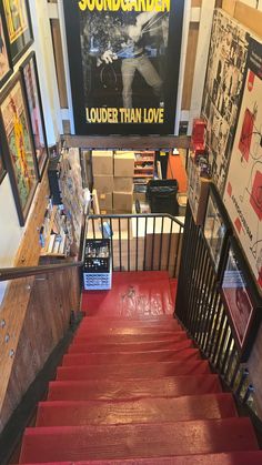 there is a red carpeted stair case on the stairs