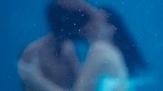 a blurry image of a woman's face and body in the blue water