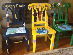 three children's chairs with writing on them sitting in front of a fire place