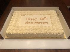 a 50th anniversary cake in a box on a table