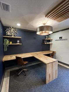 an office with two desks and shelves on the wall