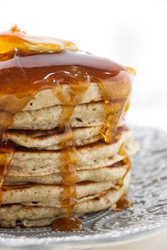 a stack of pancakes covered in syrup on a plate