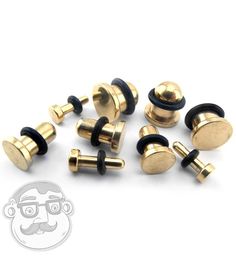 several brass and black knobs on a white background