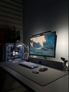 a computer monitor sitting on top of a desk next to a keyboard and mouse in front of it