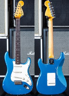 two electric guitars sitting next to each other