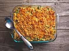 a casserole dish with broccoli, cheese and bread crumbs