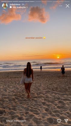 a girl walking on the beach at sunset with her back turned to the camera, and people in the background