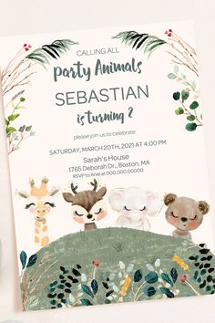 an animal themed birthday party is set up on a white background with greenery and foliage