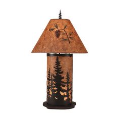 a lamp that is sitting on top of a table with a pine tree design on it