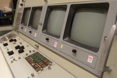 old televisions are lined up on display in a room with no people around them