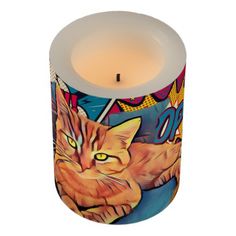 a lit candle with an image of a cat on it