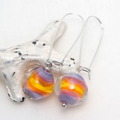 A pair of handmade lampwork glass earrings with long kidney wire hoops. All metal parts are high quality sterling silver. They measure 5.5cm long. The beads can easily be removed from the hooks so you can swap different dangles onto the ear wires. This is the exact item you will receive. It is only available on Etsy. All of the lampwork beads in my ETSY shop were made by me in my home studio in Sydney and have been annealed in my digital kiln to remove stress and prevent cracking. I do my best t Lavender Sunset, Lampwork Bead Jewelry, Lampwork Earring, Handmade Lampwork Bead, Glass Earrings, Lampwork Beads, Glass Jewelry, Cute Jewelry, Ear Wires