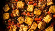 tofu and vegetables in a skillet ready to be cooked for the dinner guests