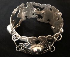 "A beautifully crafted vintage solid silver bracelet from Mexico. Made of five highly decorated curved panels connected with silver rings. Hook clasp. Designs include heavy engravings, ropes, and dimpled spheres. This piece measures 7 6/8\" in length and 1 1/8\" in width. Weight is 49.6 grams. Bracelet, circa 1930s, is in excellent vintage condition. Enjoy! *(International Buyers are welcome - however, please email me so I can check the shipping rate for you before committing to buy.) b/t" Antique Silver Oyster Bracelet, Vintage Adjustable Sterling Silver Bracelet For Ceremonial Occasions, Adjustable Vintage Sterling Silver Ceremonial Bracelet, Vintage Adjustable Sterling Silver Bracelet For Ceremonial, Ornate Stamped Bracelet Jewelry, Solid Silver Bracelets, Advertising Graphics, Pin Jewelry, Hook Clasp