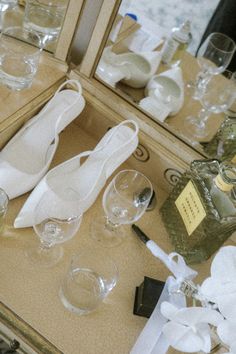 white shoes and wine glasses on a table