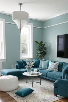 a living room filled with furniture and a flat screen tv mounted to the side of a wall