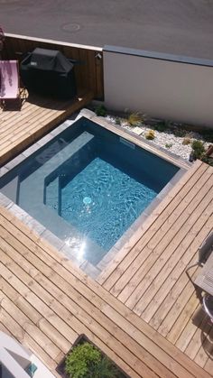 an above ground pool surrounded by wooden decking