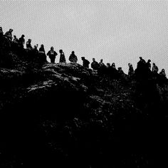 a group of people standing on top of a mountain