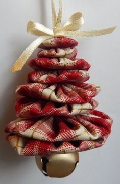 a red and white christmas tree made out of burlocks hanging from a hook