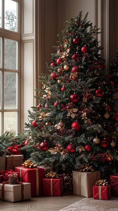 a christmas tree with presents under it in front of an open window, surrounded by red and gold ornaments