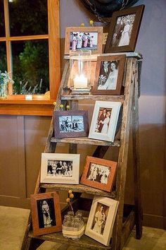 an old ladder with pictures and candles on it