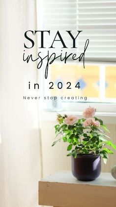 a potted plant sitting on top of a table next to a window with the words stay inspired in it