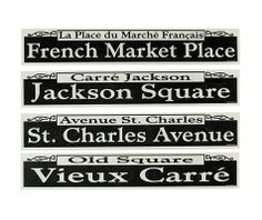 four black and white street signs with french market place on one side, jackson square, st charles avenue