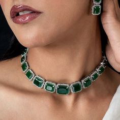 This Manish Malhotra Jewelry Inspired Emerald Choker Necklace. This emerald necklace also matches a lot of pieces from Harry Winston. Enhance your neckline with a stunning Emerald Green Necklace that exudes elegance and allure. Alternatively, for a touch of opulence, choose a Green Diamond Necklace. Add a dazzling sparkle to your look with CZ or cubic zircon embellishments. Embody the allure of emerald and green hues to elevate your style and leave a lasting impression. *𝐏𝐑𝐎𝐃𝐔𝐂𝐓 𝐃𝐄𝐓𝐀𝐈𝐋* * Material: Brass * Plating: White Rhodium Plated * Stone: AAA-quality CZ diamond & Emerald. *𝐃𝐈𝐌𝐄𝐍𝐒𝐈𝐎𝐍𝐒*  Necklace * Weight: 41 gm * Design Length: 9.6  inches * Total Length with Closure: 16.6 inches * Width: 0.7 Inches  Earrings * Weight: 7 gm each * Length: 1.6 Inches * Width:  0. Emerald Jewelry Necklace, Emerald Jewelry Set, Emerald Choker, Emerald Diamond Necklace, Ethereal Jewelry, Emerald Green Necklace, American Diamond Jewellery, Green Stones, Statement Choker