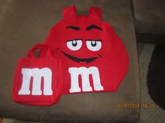 a red m and m beanie with two matching bags