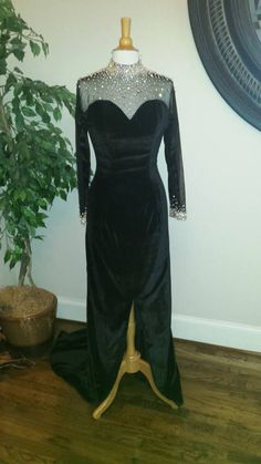 Style #1101 is one of our long sleeve black velvet evening gowns that has been in the collection for a while as it is timeless. Elegant Long Sleeve Gown For Prom Season, Elegant Long Sleeve Prom Gown, Elegant Long Sleeve Gown For Prom, Glamorous Evening Dress With Sheer Sleeves And Fitted Bodice, Formal Long Sleeve Fitted Evening Dress, Formal Fitted Long Sleeve Evening Dress, Fitted Long Sleeve Evening Dress With Sweep Train, Glamorous Gown With Sheer Long Sleeves, Long Sleeve Evening Dress With Fitted Bodice For Cocktail