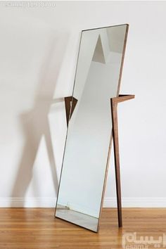 a large mirror sitting on top of a wooden floor