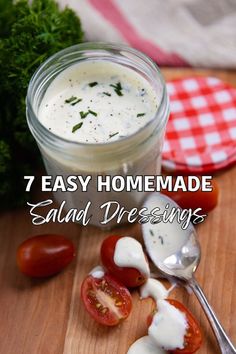 an image of homemade salad dressing in a jar with tomatoes and parsley on the side