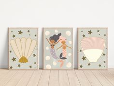 three little mermaids are hanging on the wall next to each other, with stars and seashells