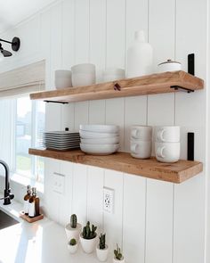 the instagram page on instagram com features white dishes and wooden shelvings