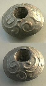 two silver beads sitting on top of a table