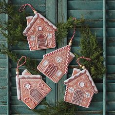 three gingerbread house ornaments hanging on a door