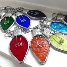 six different colors of glass on a silver chain