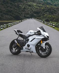 a white motorcycle parked on the side of a road