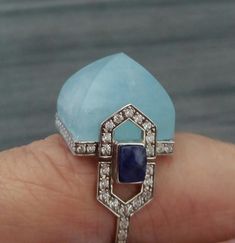 Unique and classic handmade Art Deco Style cocktail ring with Natural Aquamarine Pyramid measuring 16x16 mm set in a 14 kt yellow gold mounting,including full cut diamonds and 2 small Blue Sapphires baguettes on the sides. Art Deco Blue Diamond Ring With Single Cut Diamonds, Art Deco Blue Jewelry With Single Cut Diamonds, Blue Art Deco Jewelry With Single Cut Diamonds, Natural Aquamarine, Art Deco Style, Ring Ring, Cocktail Ring, Deco Style, Cocktail Rings