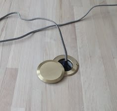 an object is laying on the floor with a cord in it's middle and two discs attached to each other