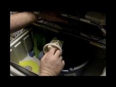 a man is opening the door of an open refrigerator with his hand on the handle