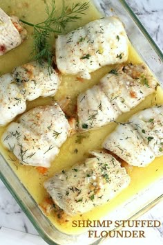 fish fillets in a casserole dish with lemon and dill garnish