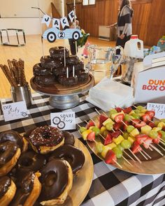 donuts, strawberries and other snacks are on the table