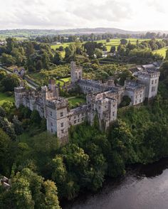 an aerial view of a castle surrounded by trees