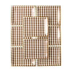 brown and white gingham checkered paper napkins with gold trimming on the edges